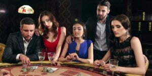 two men and three women are sitting on a poker table, thinking of their next mvoe