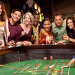 happy people sitting around a casino table