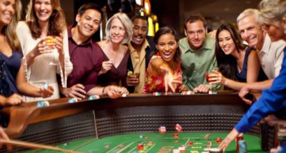happy people sitting around a casino table