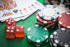 casino chips and cards on a green table