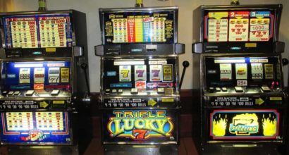 three slot machines standing next to eachother